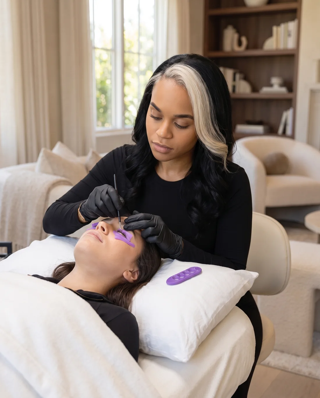 Nadia Blanco performing an LVL lash lift on a client at home